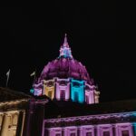 San Francisco city hall lit up with trans flag colors.